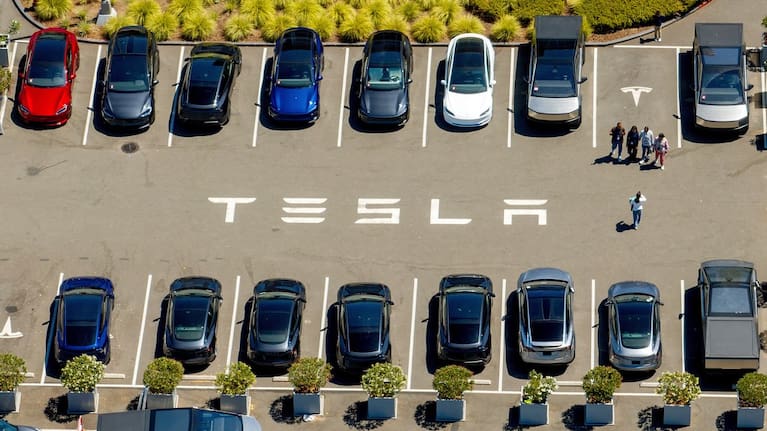 Tesla vehicles line a parking lot at the company's Fremont, Calif., factory on Aug. 5, 2025.