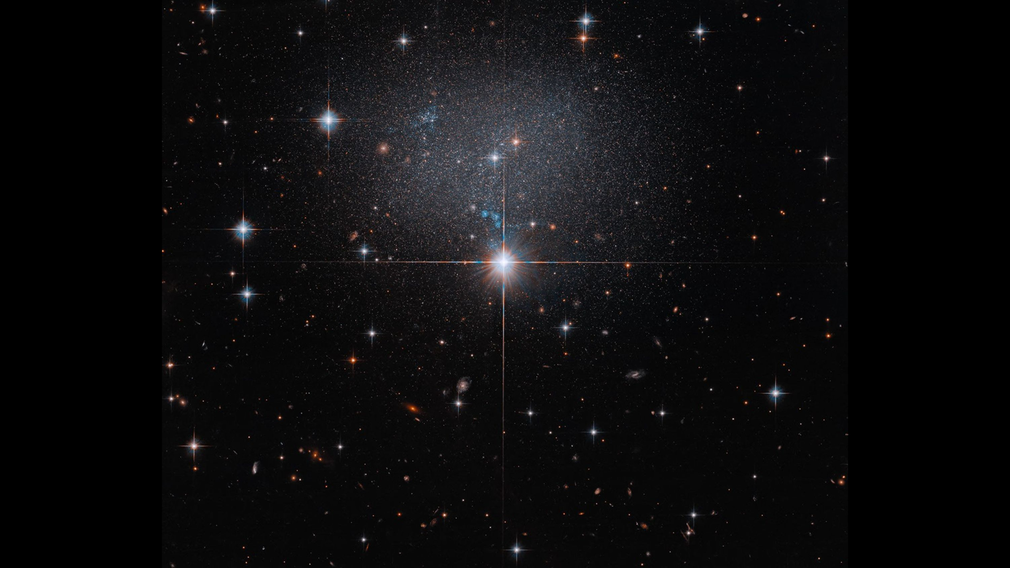 A bright central star stands out in a field of stars against the dark backdrop of space.