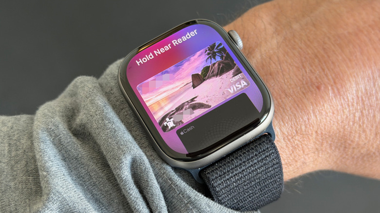 Closeup of an Apple Watch, ready for a contactless payment, on a person's wrist