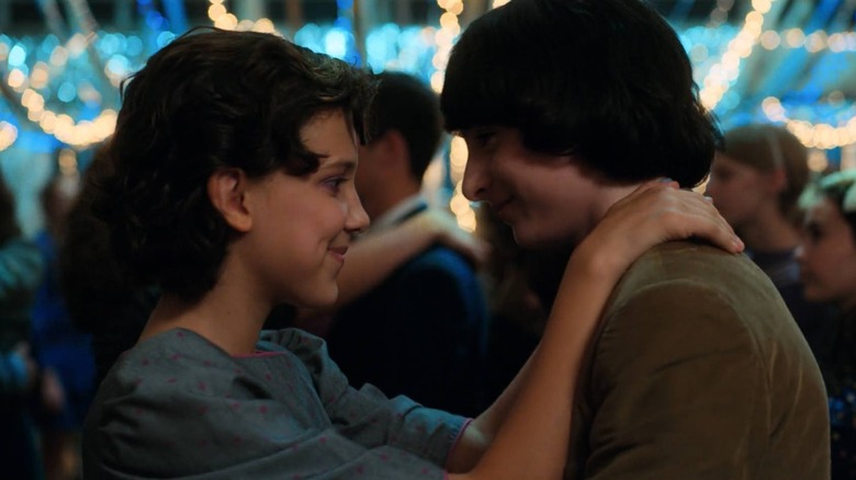 Millie Bobby Brown as Eleven dancing with Finn Wolfhard as Mike at a dance in Stranger Things
