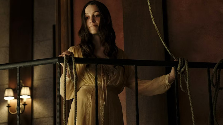 Nell Crain standing on a balcony next to a hanging rope