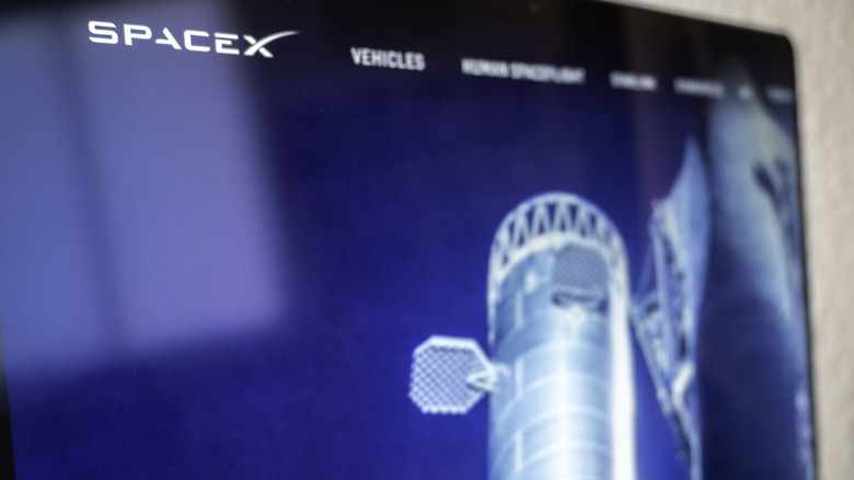 Computer screen featuring SpaceX logo and rocket design