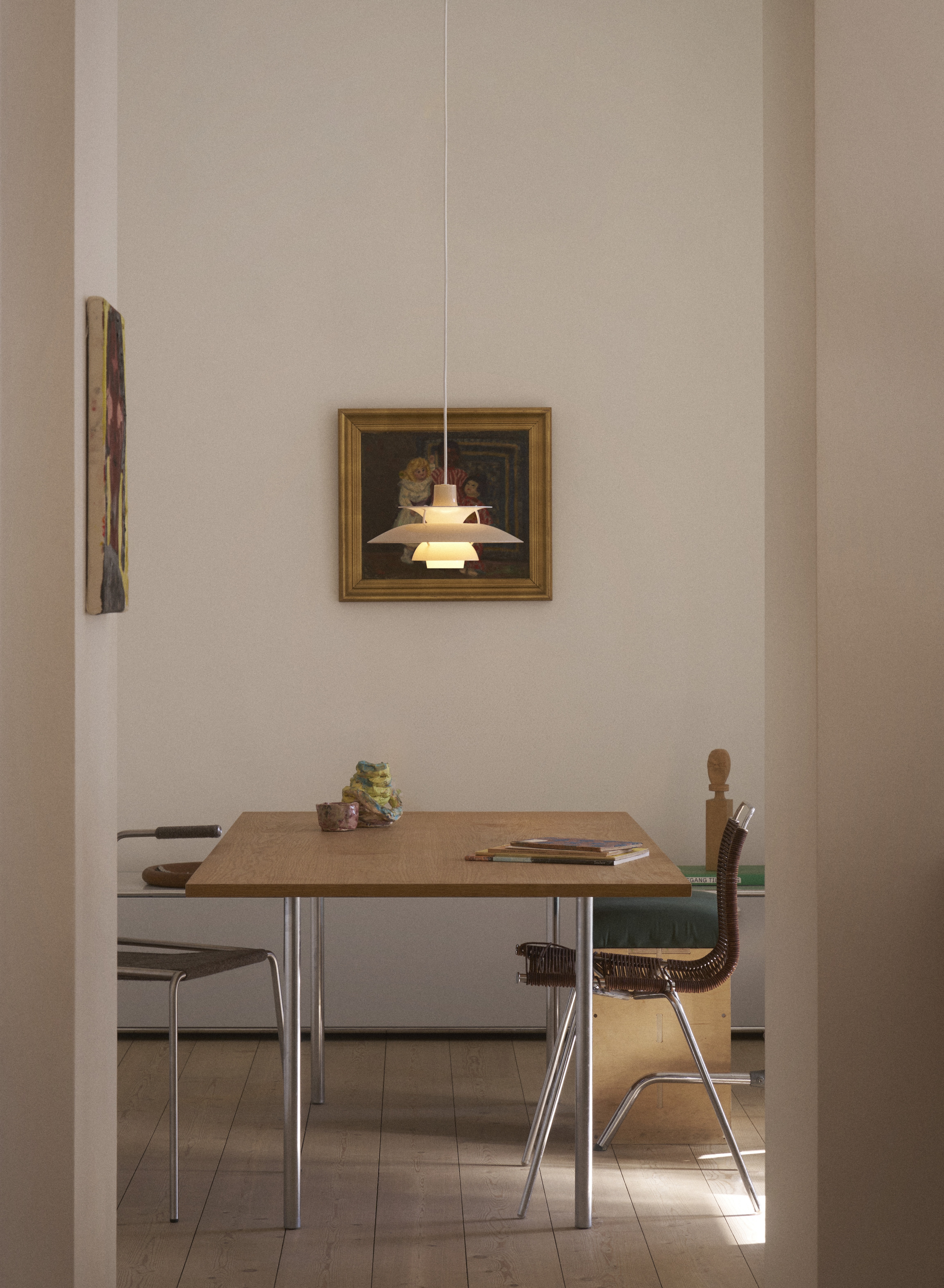 A Louis Poulsen PH5 pendant above a dining table