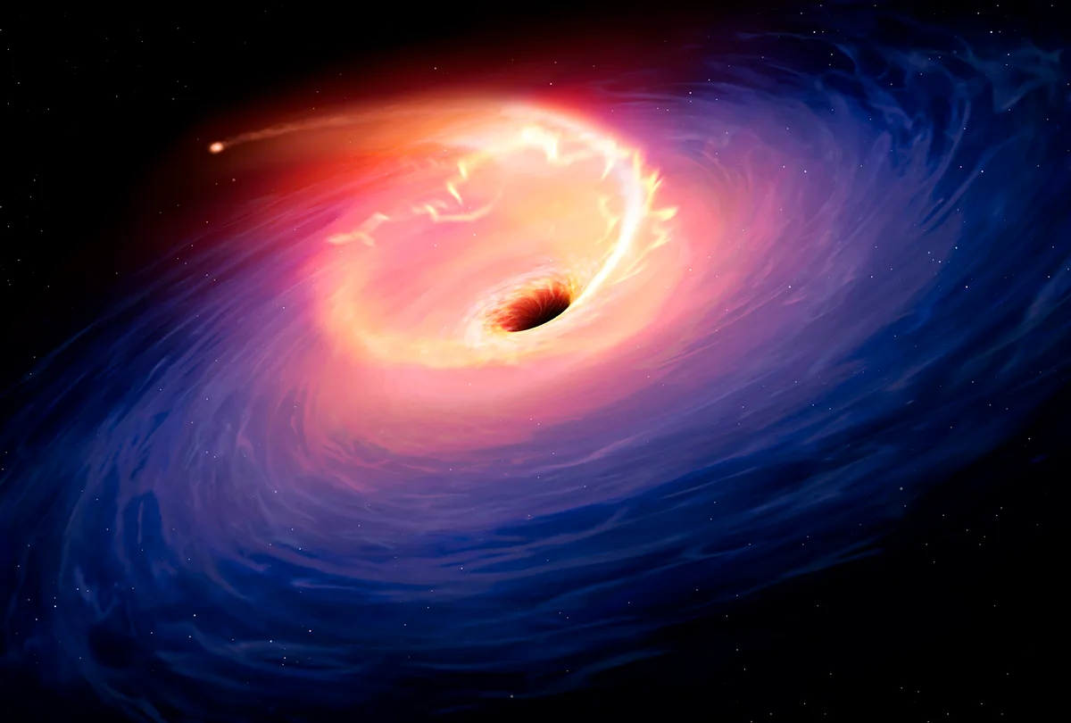 Artwork depicting a tidal disruption event, when a star is torn apart by a black hole. Credit: Mark Garlick / Science Photo Library / Getty Images
