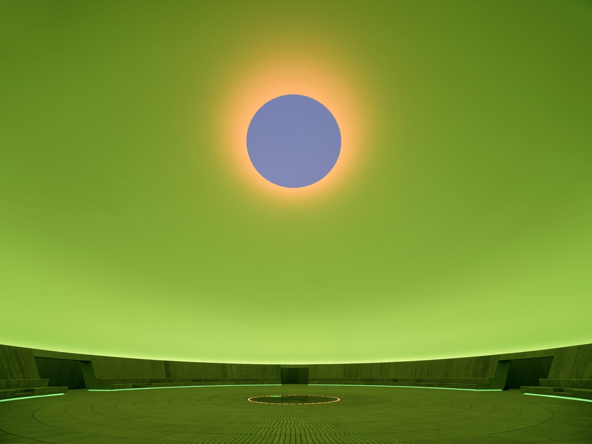 a large-scale light exhibition by James Turrell featuring a gray hole in a green dome