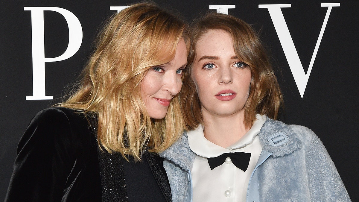 Uma Thurman and Maya Hawke standing together posing for a photo