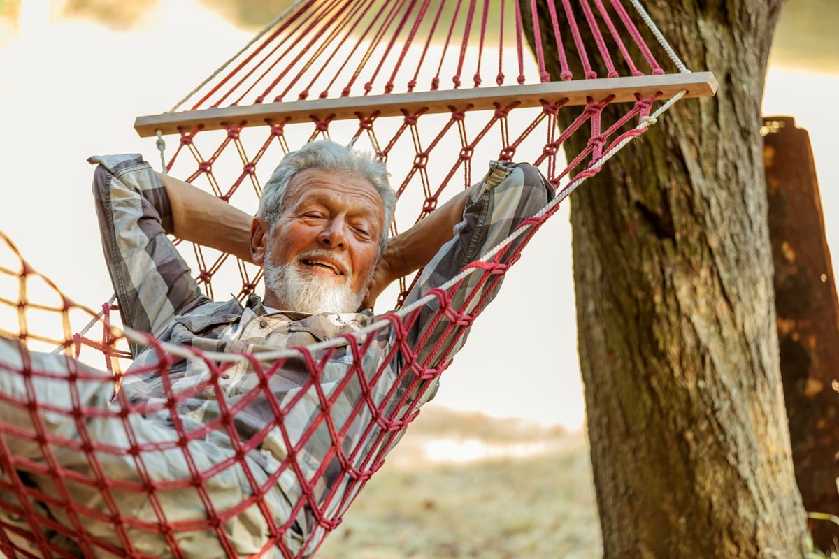 Someone is in a hammock, smiling.