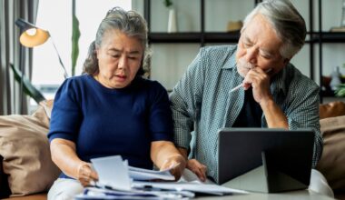 A stressed couple looking at documents together.
