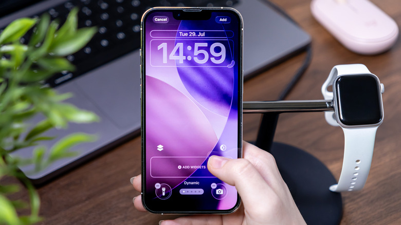 A person adding Widgets to their iPhone Lock Screen.