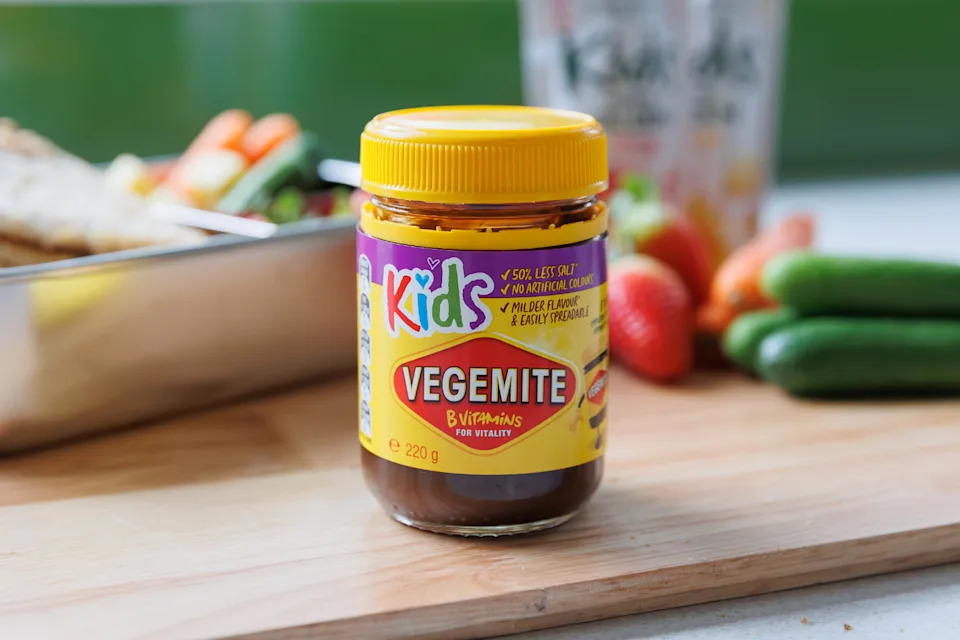 A jar of the new Vegemite Kids product on a chopping board.