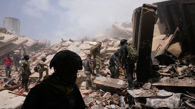 Venezuelan police search for survivors through the rubble in La Guaira, Venezuela, Friday, June 26, 2026, two days after twin earthquake struck the country.