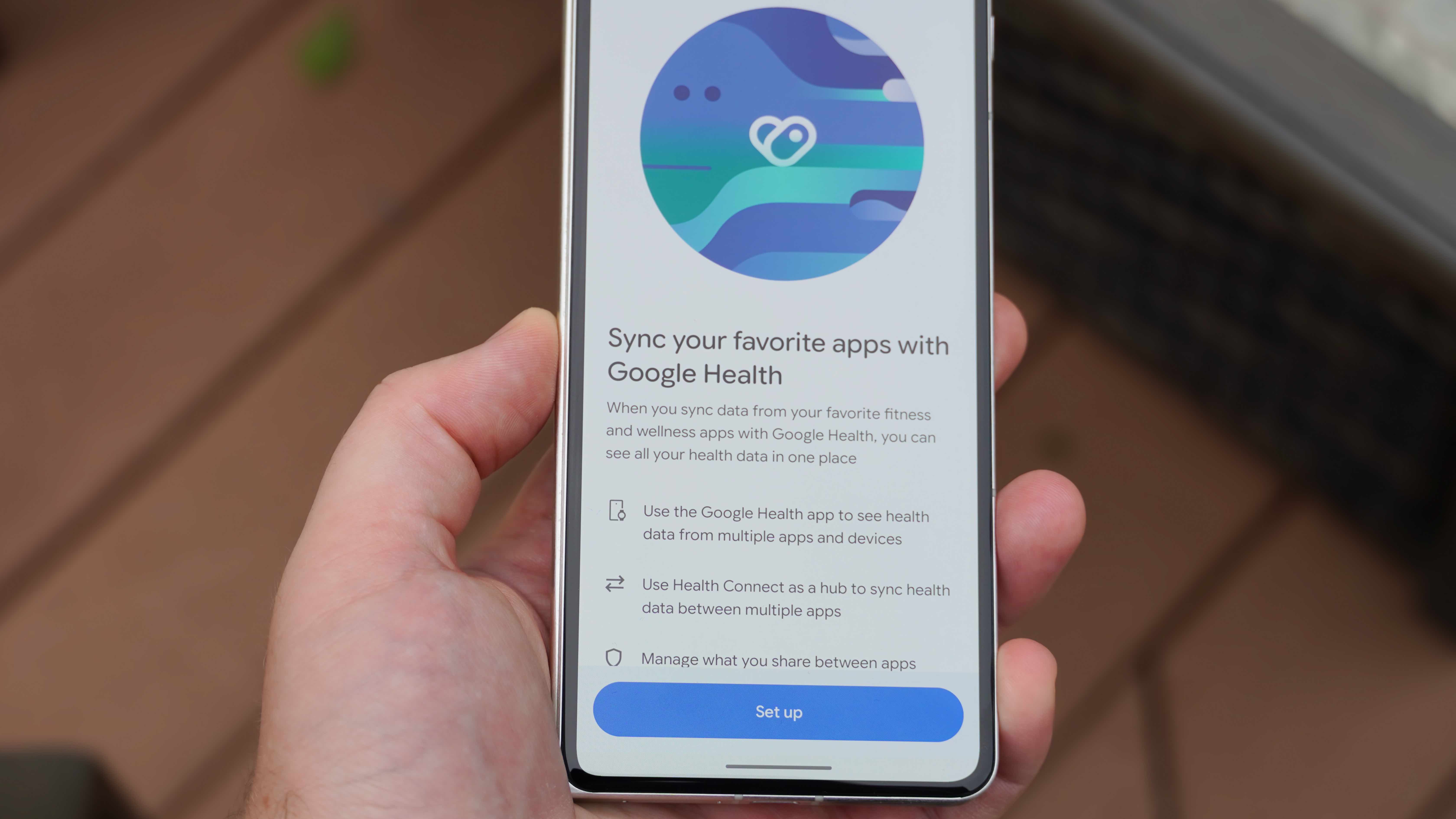 The Fitbit Air in a Lavender band and the Google Health app settings.