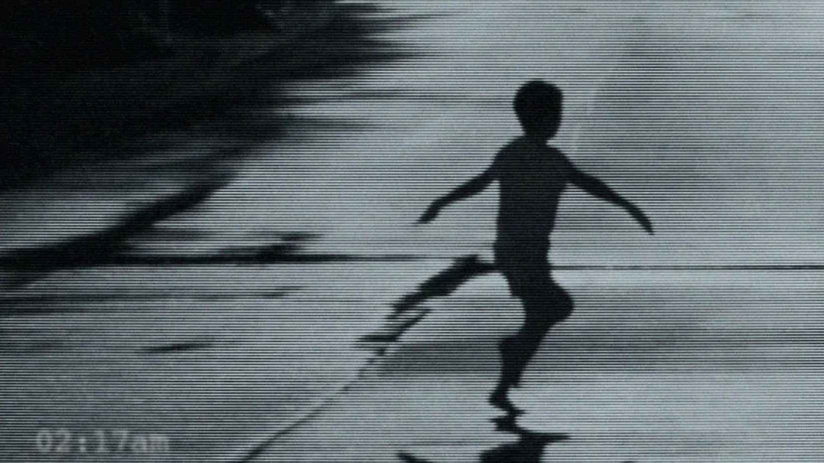 A boy running with his arms outstretched in Weapons