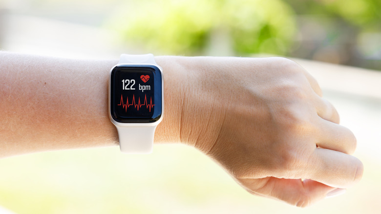A smartwatch on a person's wrist displaying health information