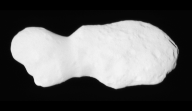 A white rock in front of a dark background.