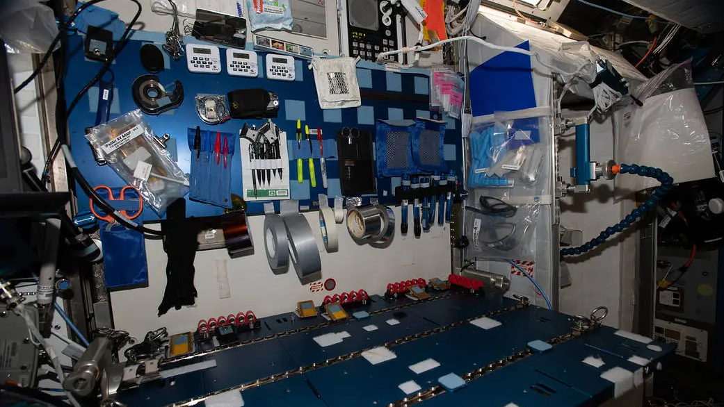 a cluttered work bench with blue velcro