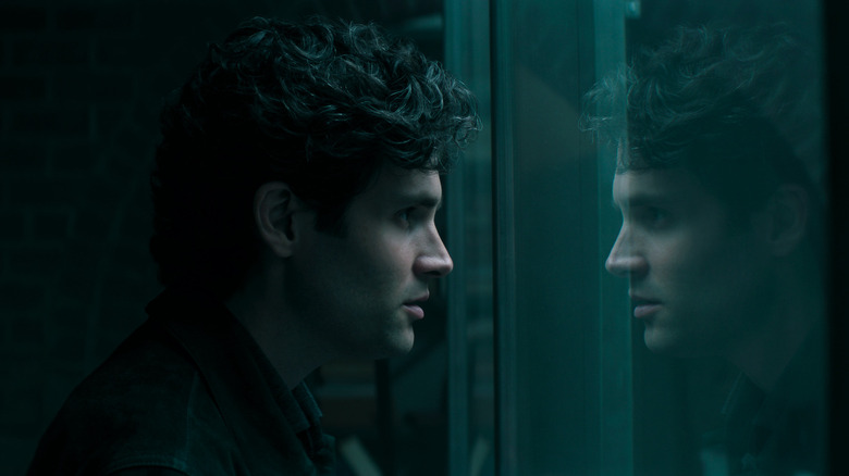 Joe Goldberg (Penn Badgley) stares at his reflection in You