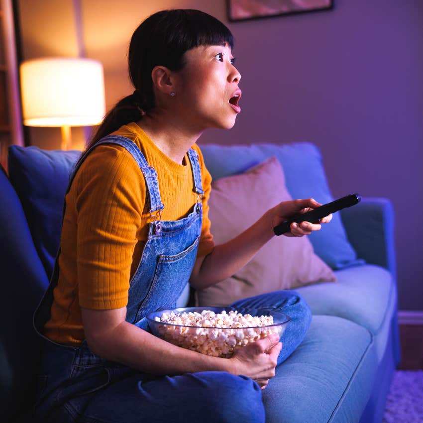 woman shocked while watching a sci-fi