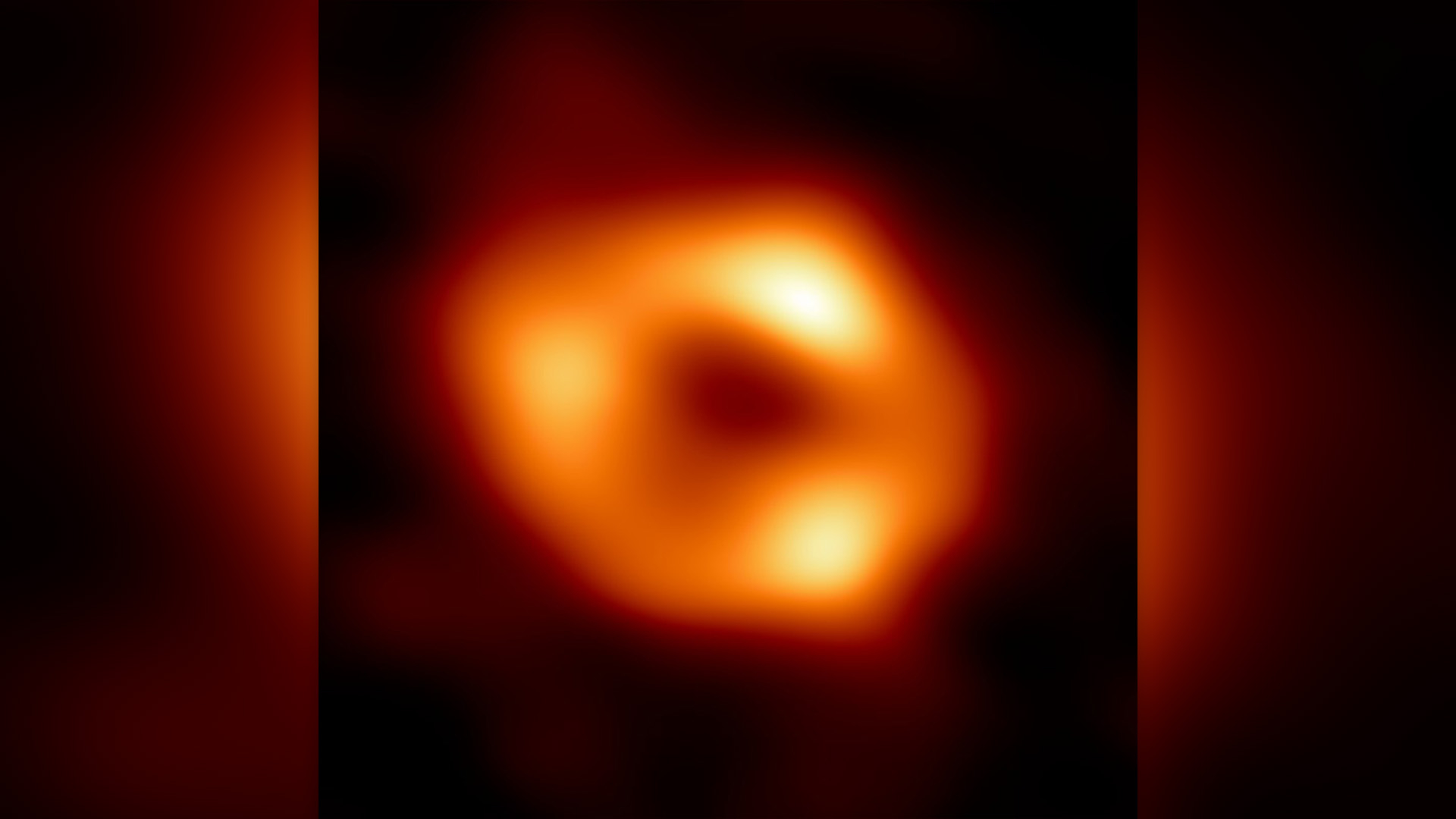 An orange doughnut-shaped object.
