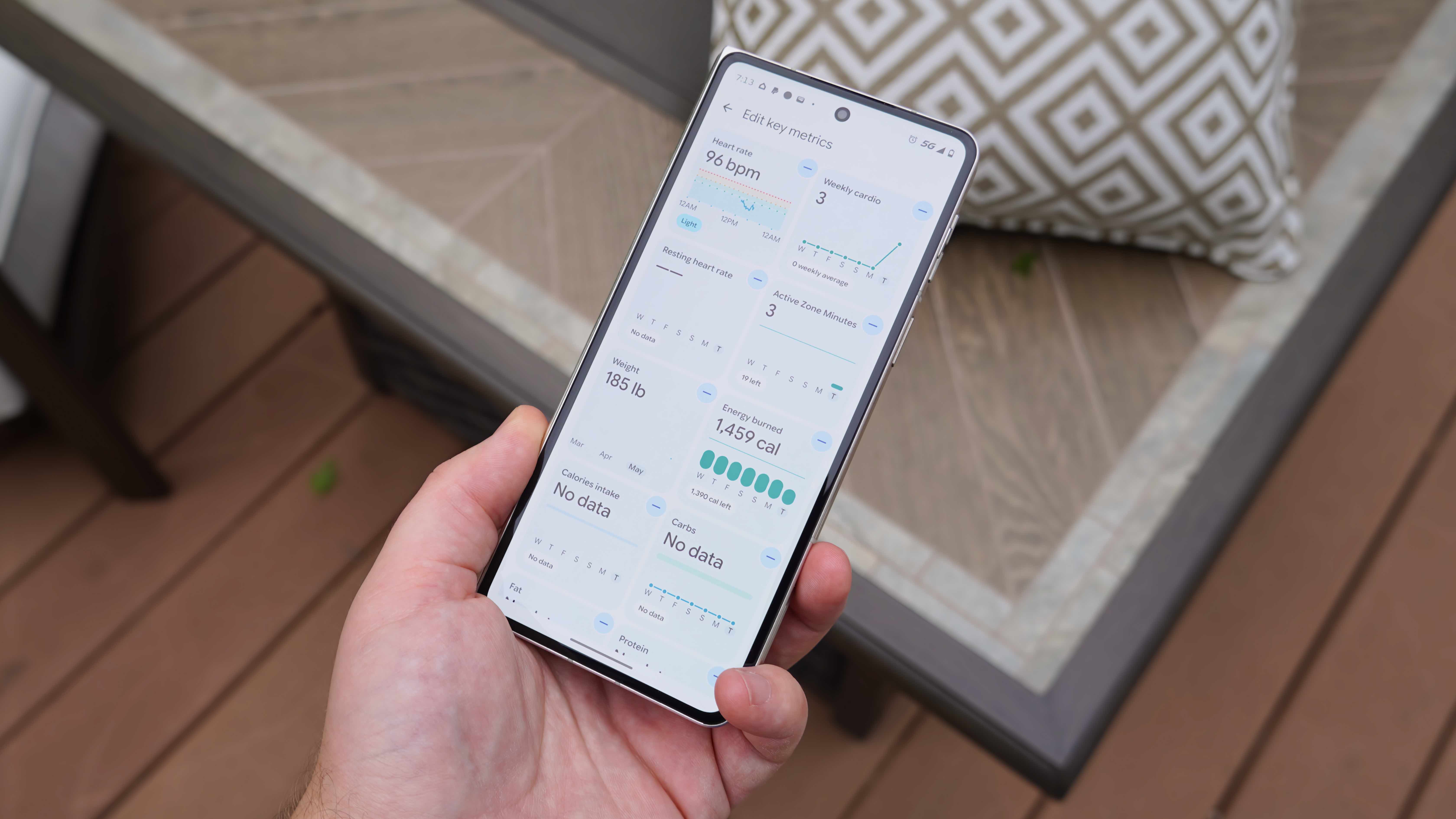 The Fitbit Air in a Lavender band and the Google Health app settings.
