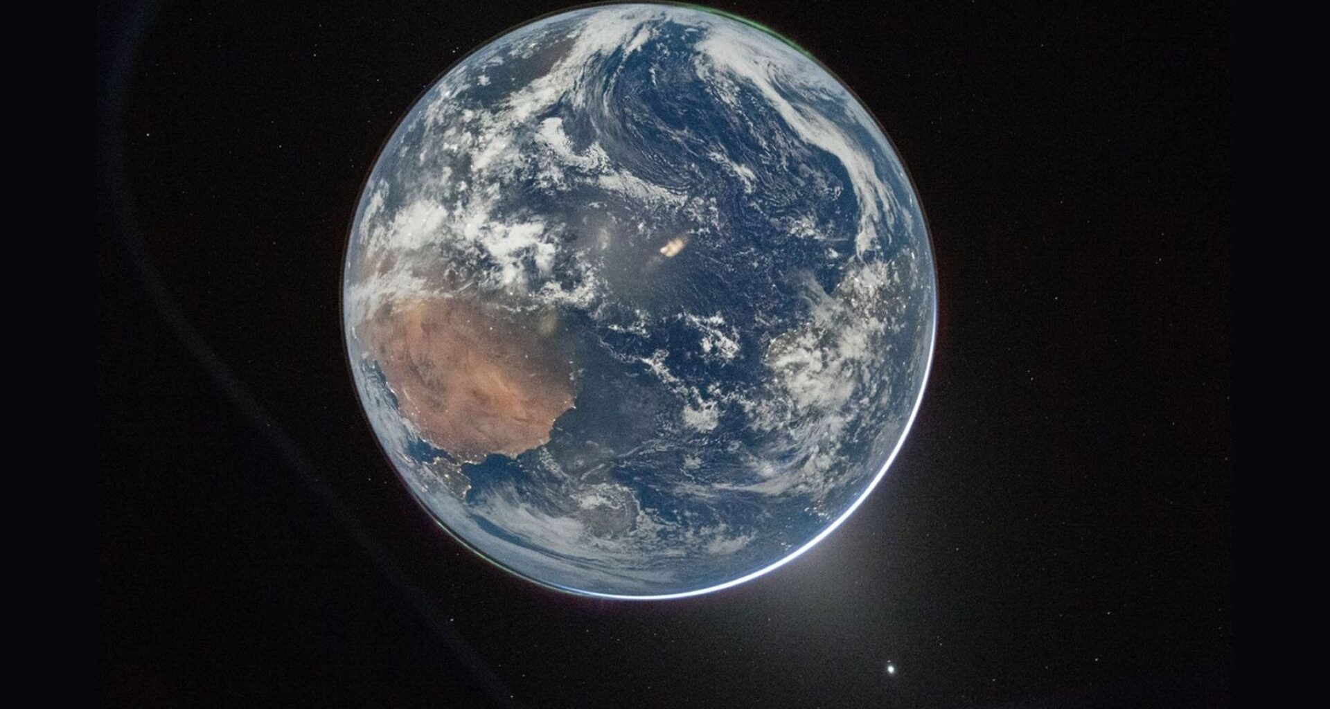 A view of Earth with a glow behind it.