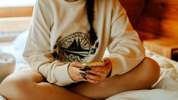 Portrait of a teenage girl with mobile phone.