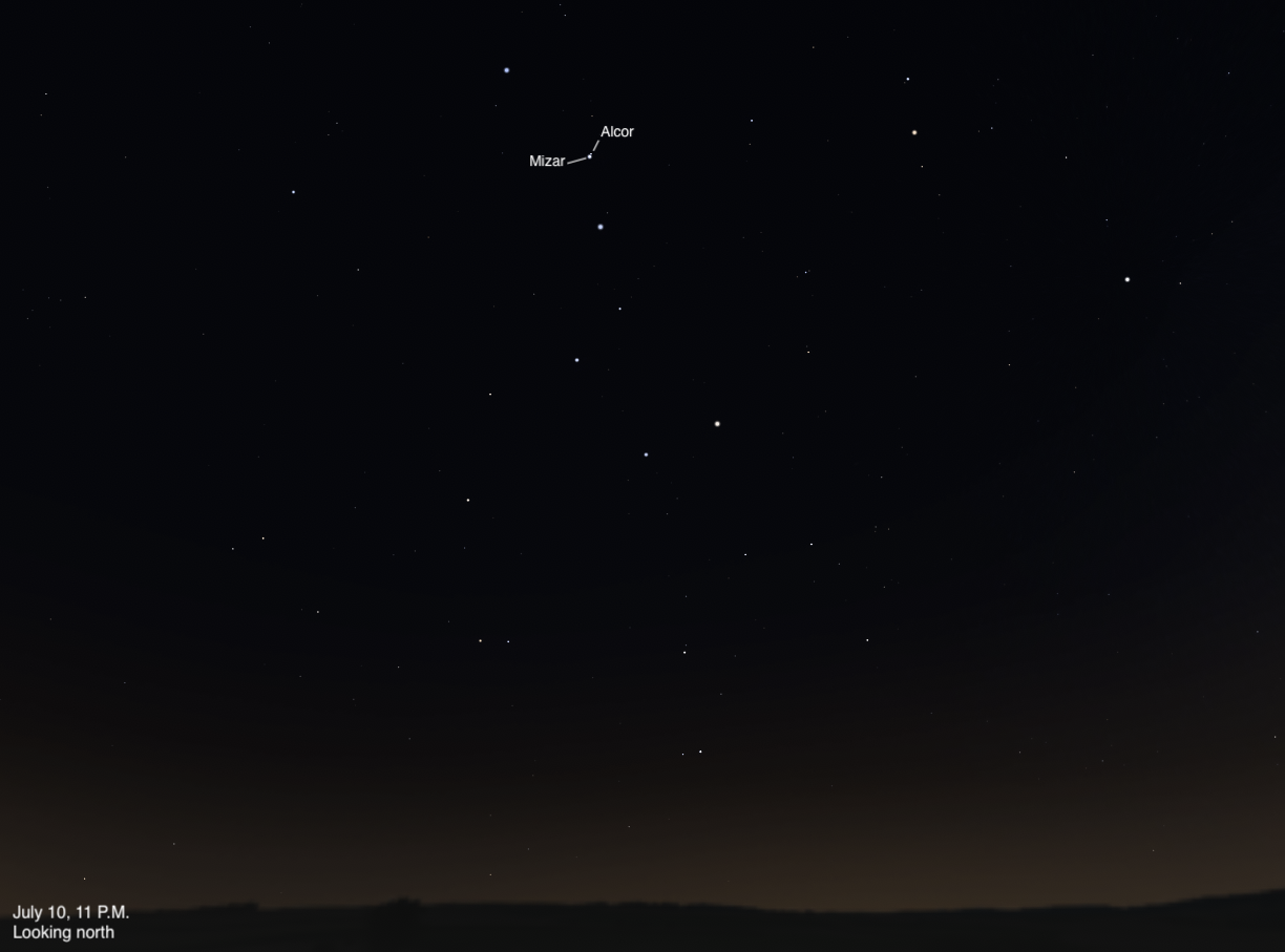 Sky chart showing the northern sky on July 10, 2026, at 11 p.m. The double star Mizar and its companion Alcor are labeled near the upper center of the frame, part of the Big Dipper's handle. A dark, rolling horizon is visible at the bottom.