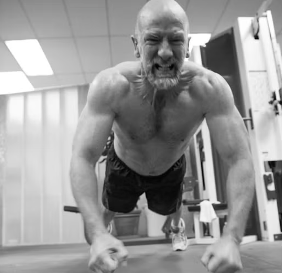 man doing intense workout in gym, exerting effort.