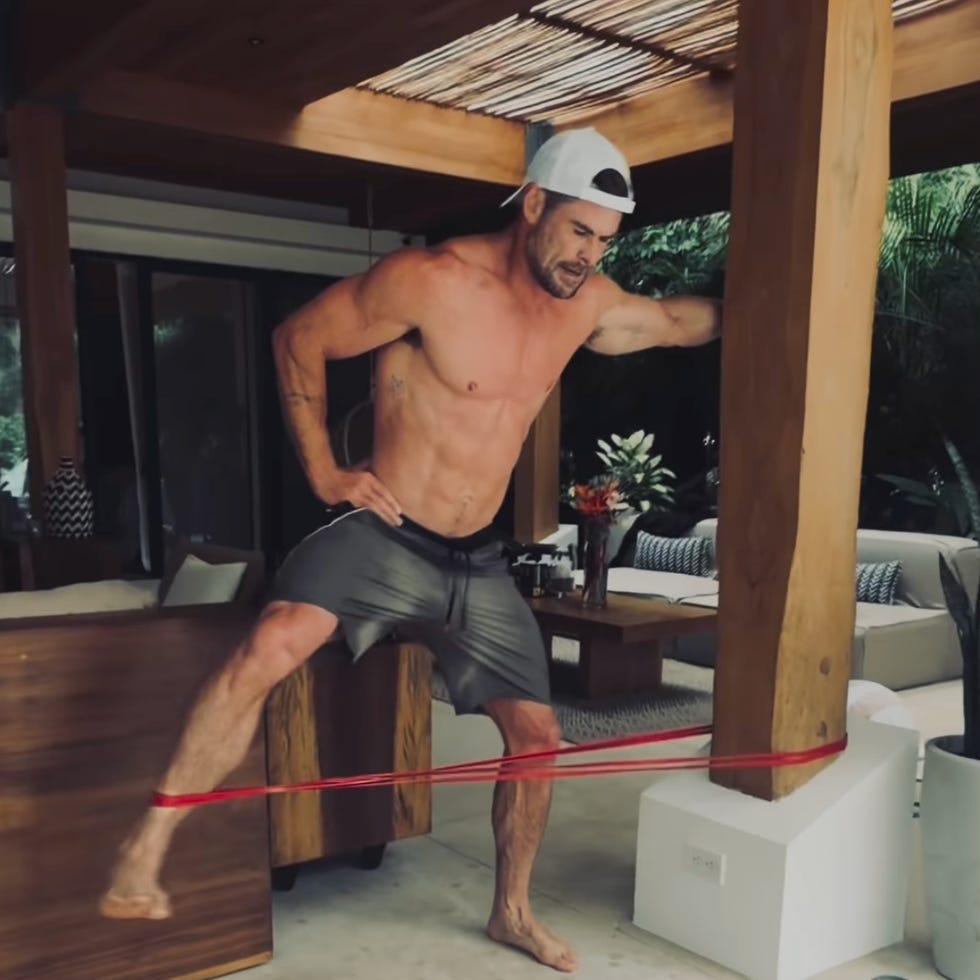 man exercising with resistance band indoors. man exercising with resistance band indoors.