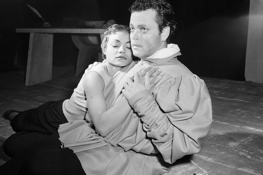 Two actors embrace in a movie. One is a black woman, the other a white man