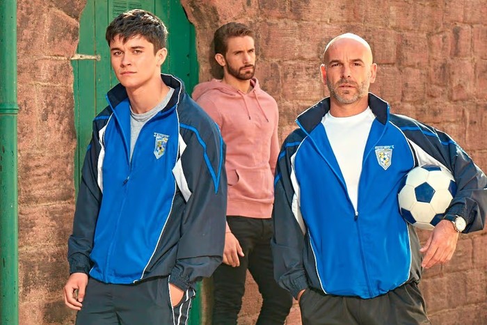 Nathan Sussex, holding a football under his arm, alongside two other Hollyoaks actors