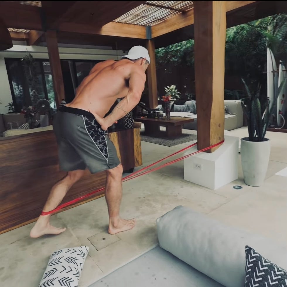 man exercising with resistance bands in a modern outdoor patio. man exercising with resistance bands in a modern outdoor patio.