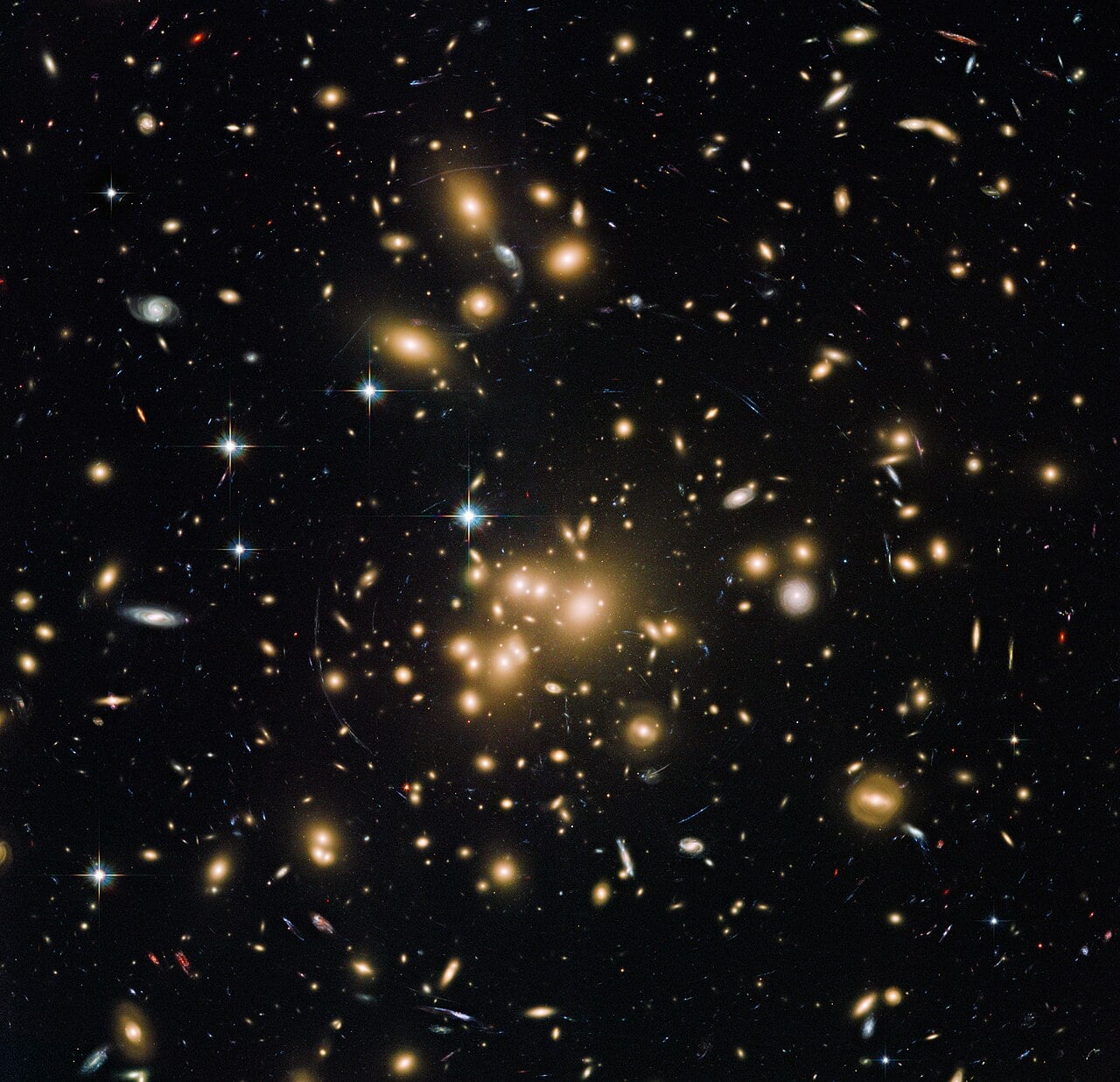 This new Hubble image shows galaxy cluster Abell 1689. It combines both visible and infrared data from Hubble’s Advanced Camera for Surveys (ACS) with a combined exposure time of over 34 hours (image on left over 13 hours, image on right over 20 hours) to reveal this patch of sky in greater and striking detail than in previous observations (Credit : ESA/Hubble)