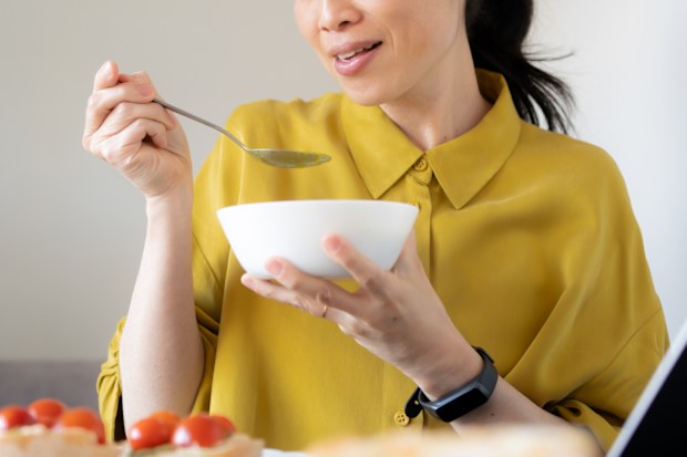Stock image of a woman eating soup