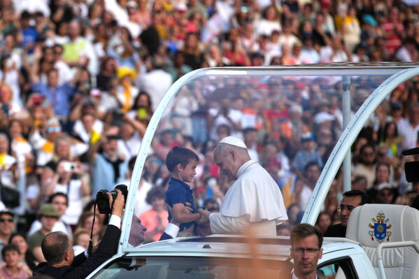 Pope Leo XIV blesses a child before a prayer vigil at Lluis Companys Olympic Stadium in Barcelona, Spain, Tuesday, June 9, 2026. (AP Photo/Emilio Morenatti)