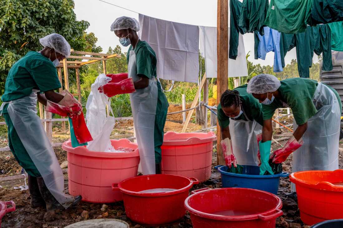 Hygiene workers assigned to the laundry unit of the Rwampara Ebola Treatment Centre clean personal protective equipment (PPE) used by healthcare workers in Ituri Province, eastern Congo, June 14, 2026.