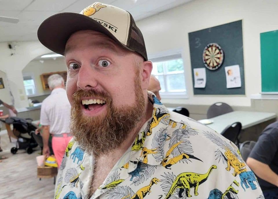 A man smiles for a photo.