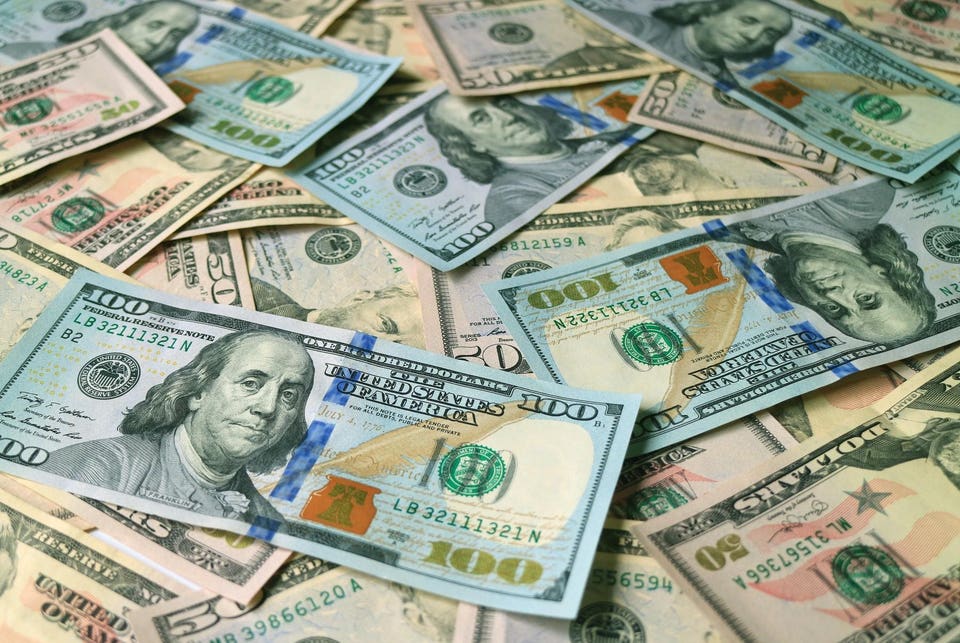 Closeup heap of United States dollar bills focus for the concept of business and wealth