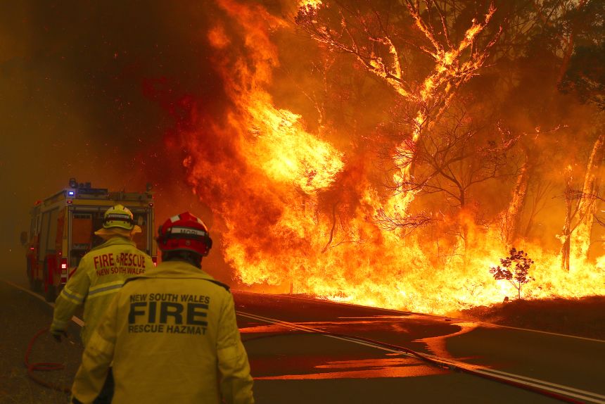 A bushfire burns next to a major road and homes on the outskirts of the town of Bilpin, Australia, on December 19, 2019.