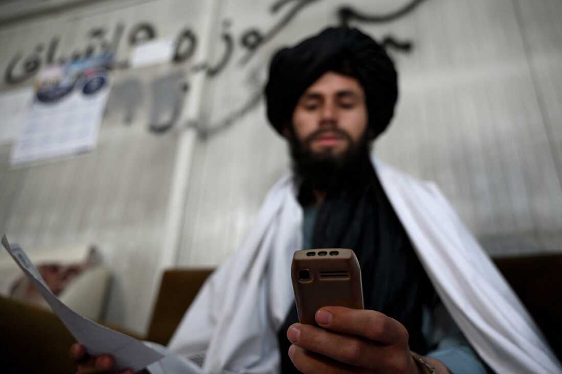 Taliban staff used to rely on smartphones. After a ban was announced, they're using feature phones — also known as "dumb phones" — which do not have a screen and are designed for calls and texts. This Taliban administrator is using such a phone at the Department of Information and Culture building in Kandahar.