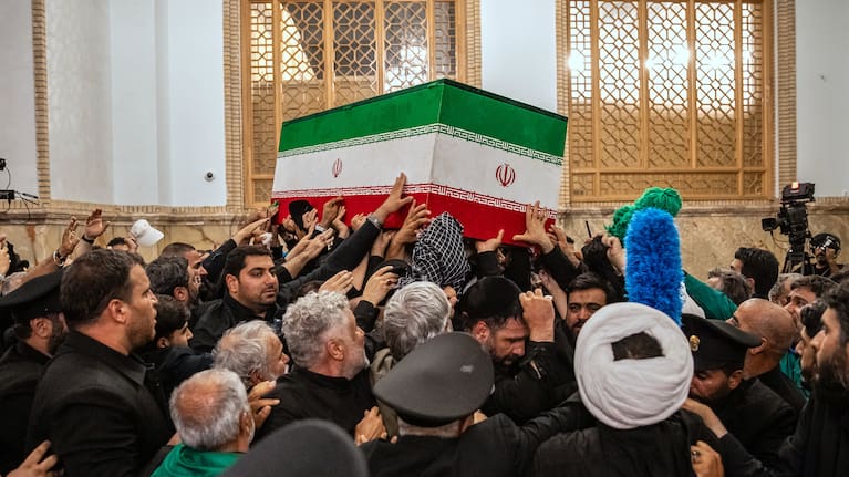 Mourners carry the coffin of the late Iranian Supreme Leader Ayatollah Ali Khamenei above the crowd for the final prayer before his burial at the Imam Reza Shrine in Mashhad.