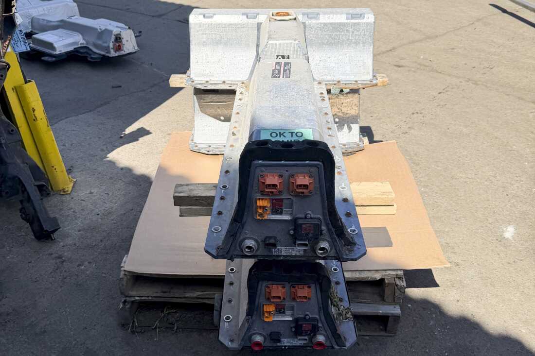 Two Chevy Volt batteries sit on a pallet at Everett Auto Parts in Brockton, Mass.