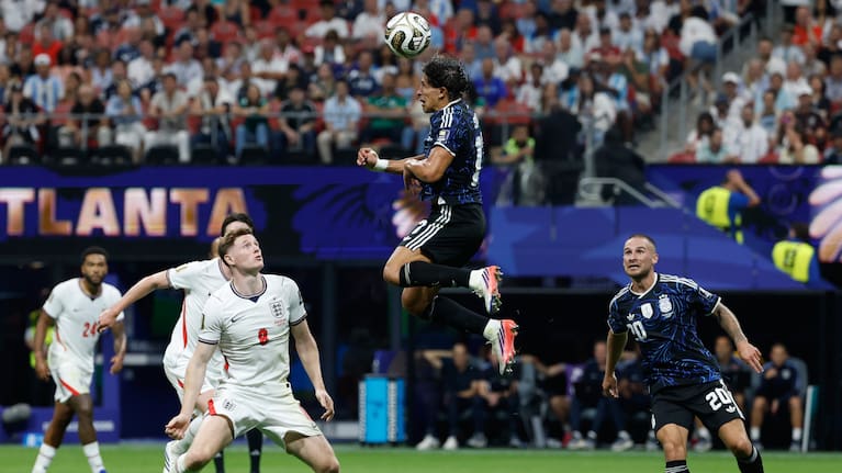 Argentina's Giuliano Simeone (17) heads the ball over England's Elliot Anderson (8) during the World Cup semifinal soccer match between England and Argentina in Atlanta, 