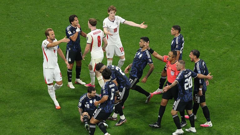 Argentina players surround referee Ismail Elfath after a foul on Lionel Messi during the FIFA World Cup 2026 Semi Final match between England and Argentina.