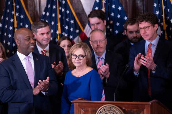 Newly appointed U.S. interim Senator Darline Graham Nordone, center, receives applause from Sen. Tim Scott (R-SC), left, and others at the conclusion of a news conference, Monday, July 13, 2026, in Columbia, S.C. (AP Photo/Sean Rayford)