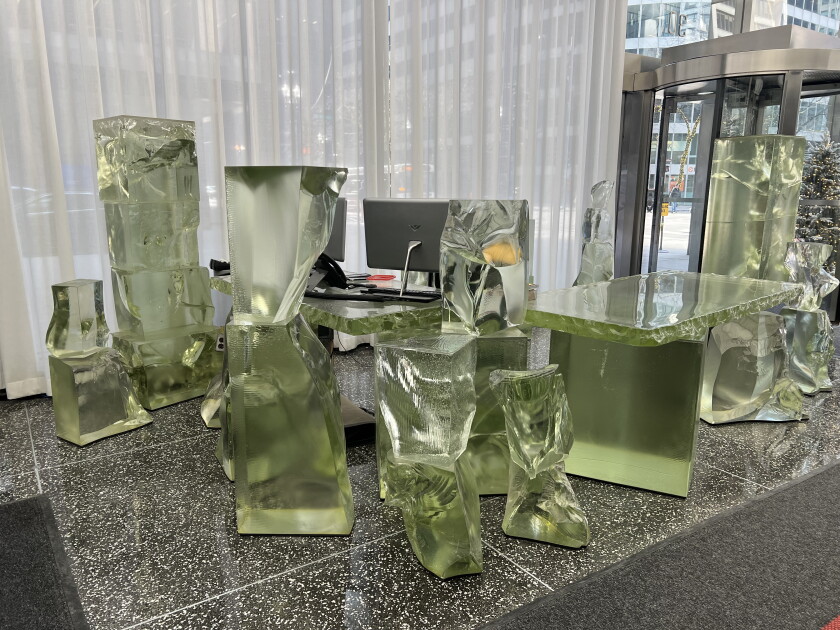 A 16-piece emerald-colored glass desk by the late architect Frank Gehry, inside the lobby of the Inland Steel Building.