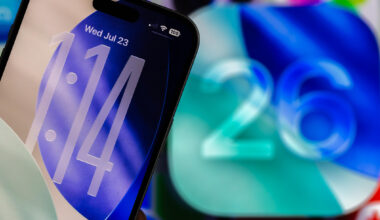 An iPhone lock screen with a clear clock next to the number 26.