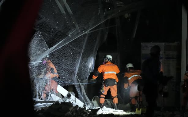 Firefighters head to conduct rescue operations at AEON Mall Kumamoto, where a gas explosion is believed to have occurred, in Kashima Town, Kumamoto Prefecture, Japan, on July 28, 2026. The explosion occurred after employees and shoppers had been evacuated following an earthquake. According to the Fire and Disaster Management Agency, part of the second floor collapsed, and many people were reportedly trapped inside. According to the Japan Meteorological Agency, the quake struck Kumamoto Prefecture around 4:27 p.m. that day, measured a maximum of 7 on Japan's seismic intensity scale, occurred at a depth of about 10 kilometers, and had an estimated magnitude of 7.1. ( The Yomiuri Shimbun ) (Photo by Kazuki Wakasugi / The Yomiuri Shimbun via AFP)