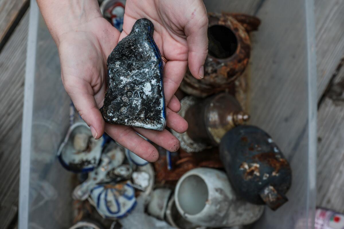 Chelsea Bayouth shows the porcelain sculptures she recovered after the Eaton fire.