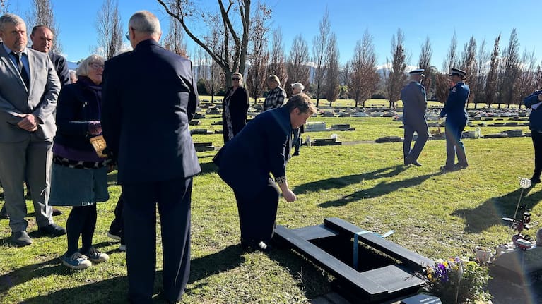 Marlborough mayor Nadine Taylor lays a sprig of rosemary on Baby Doe's casket. Taylor thanked the community for showing up for the baby in the family's stead.